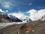 08 Trekking On The Upper Baltoro Glacier Towards Shagring Camp With Gasherbrum VI, Baltoro Kangri And Kondus Peak Gasherbrum VI, Baltoro Kangri and Kondus Peak lie ahead as we trek on the Upper Baltoro Glacier towards Shagring Camp.